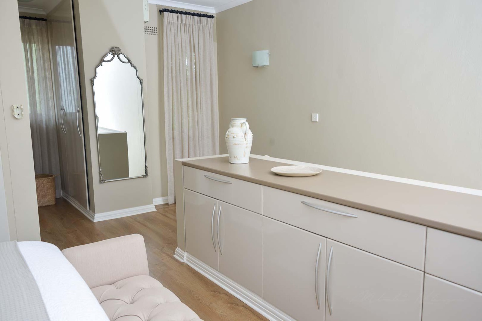 The bedroom dressing wall, with mirror and built-in wardrobes