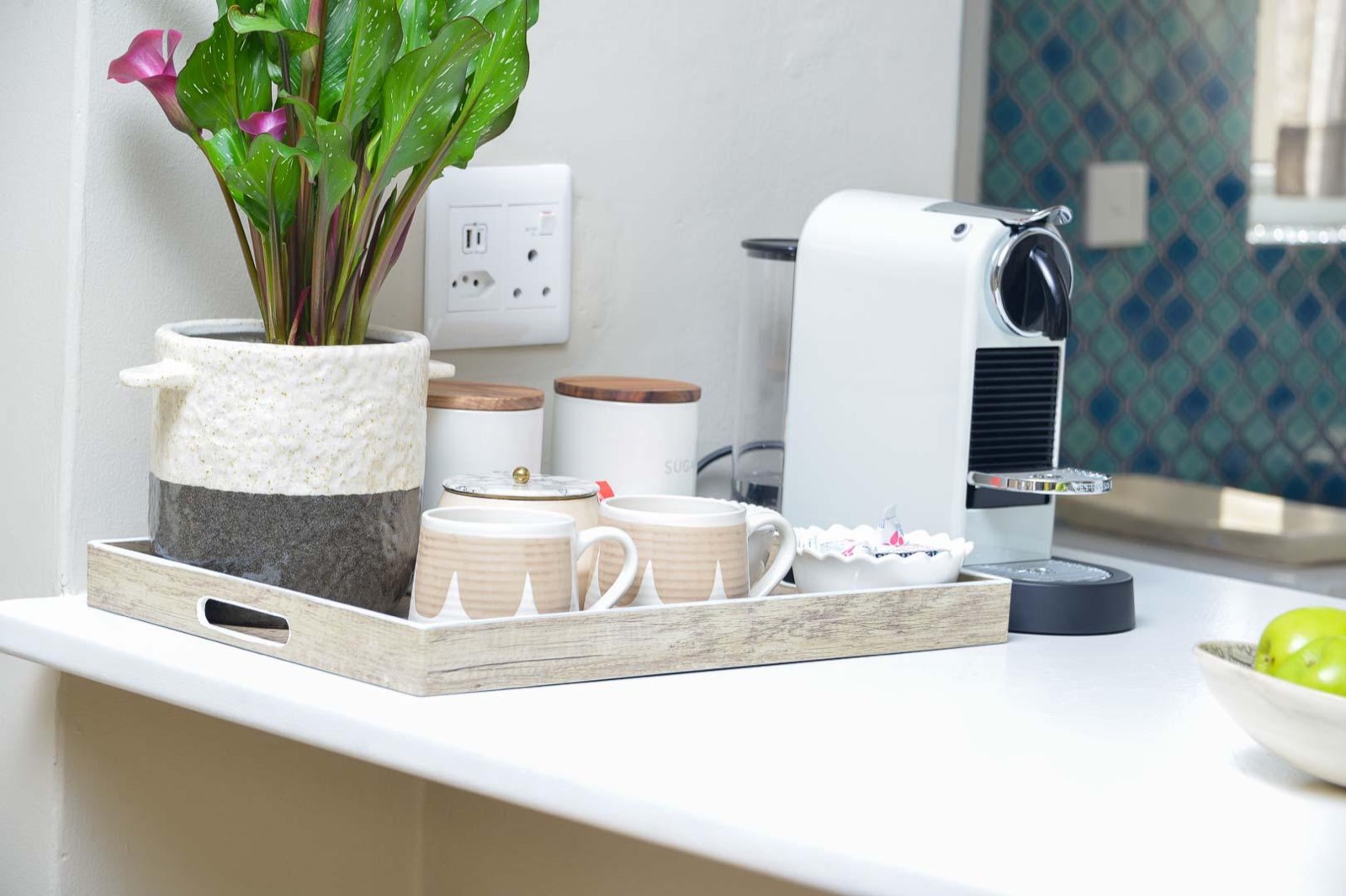 The coffee counter, with capsules, mugs and the kettle