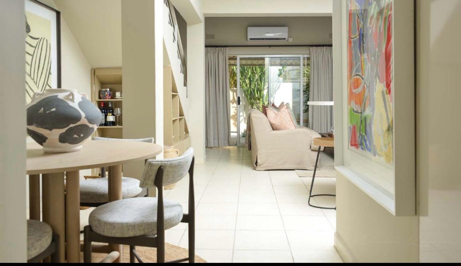 The dining nook, with a round table and the living room beyond